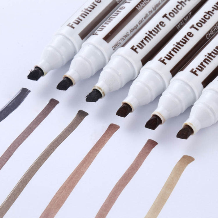 Close-up of multiple furniture touch-up pens with angled precision tips