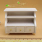White short cabinet with three drawers and open center shelf for dollhouse bathroom
