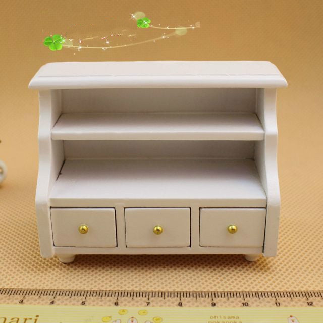 White short cabinet with three drawers and open center shelf for dollhouse bathroom