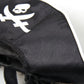 Black pirate hat fabric with white skull-and-crossed-swords emblem and stitched edge trim