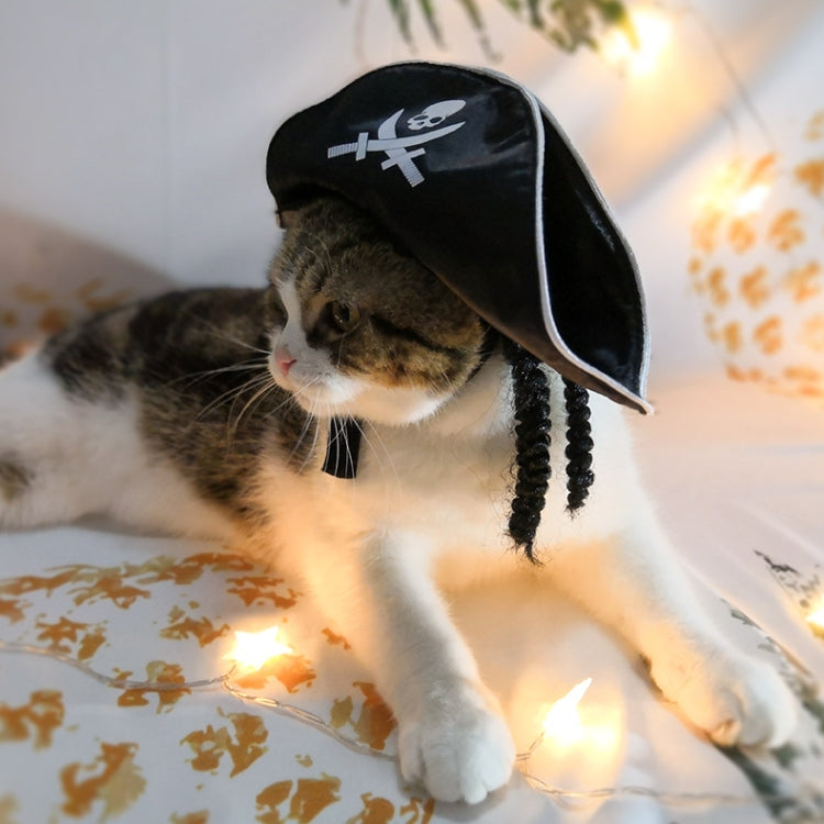 Cat wearing pirate hat for pets, black with white skull-and-crossed-swords patch and tassels