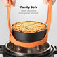 Orange silicone steamer egg cooker basket holding a steamer pot with side handles