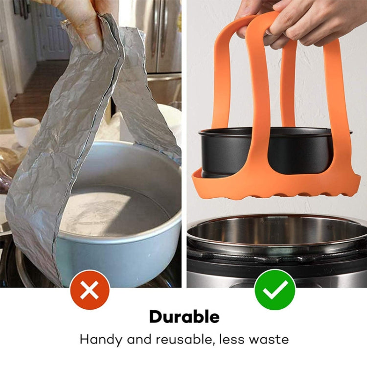 Orange silicone steamer egg cooker basket with two side handles on steamer pot