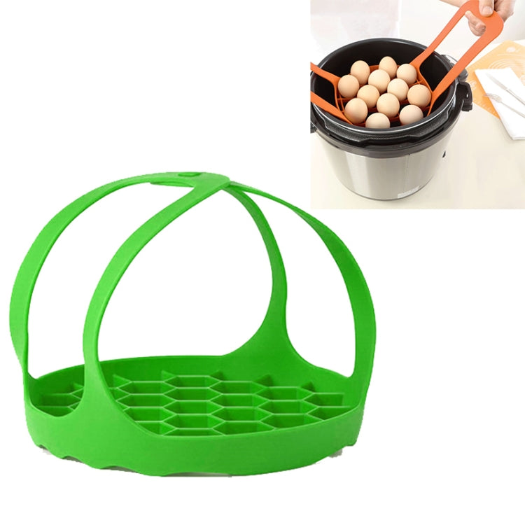 Green silicone steamer egg cooker basket with handles and egg tray grid