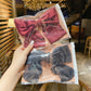 Satin bow hairpin gift set in clear sleeve, showing wine red and black bows