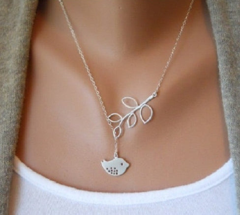 Silver leaf pendant necklace with small bird charm at center