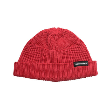 Red knitted beanie hat with ribbed brim and pom top, one-size, branded label.