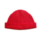 Red knitted beanie hat with ribbed brim and pom top, one-size, branded label.