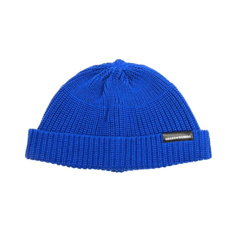 Blue knitted beanie hat with ribbed brim and pom top, one-size, branded label.