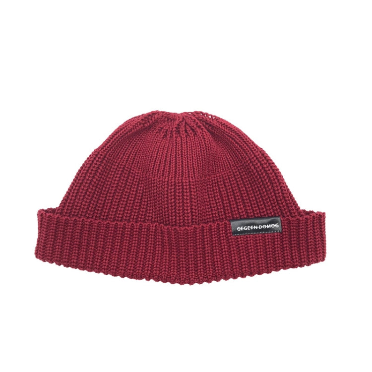 Red wine knitted beanie hat with ribbed brim and pom top, one-size, branded label.