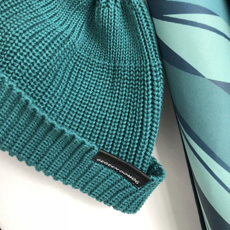 Teal short knit beanie cuff with ribbed knit and rectangular logo label