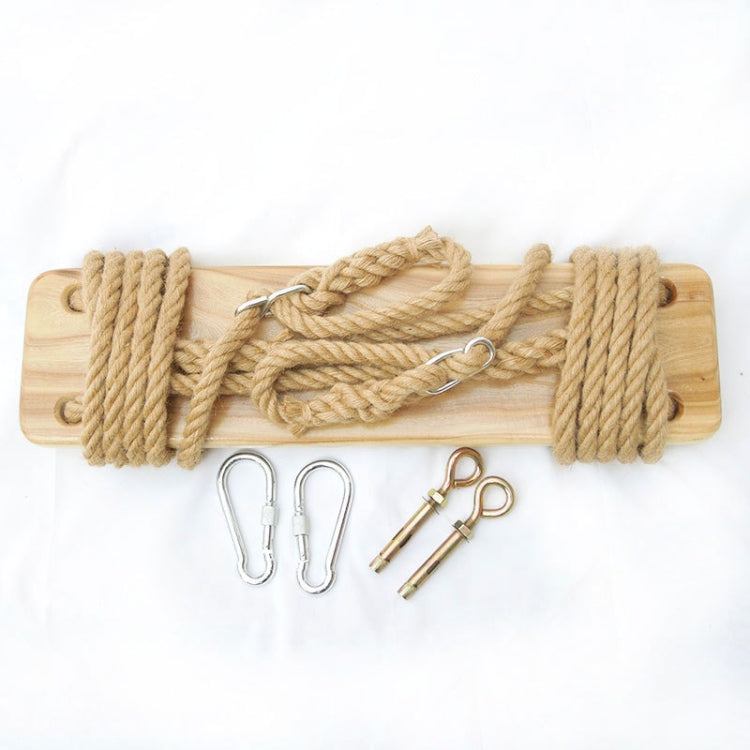 Wooden swing board with coiled tan rope and metal attachment clips
