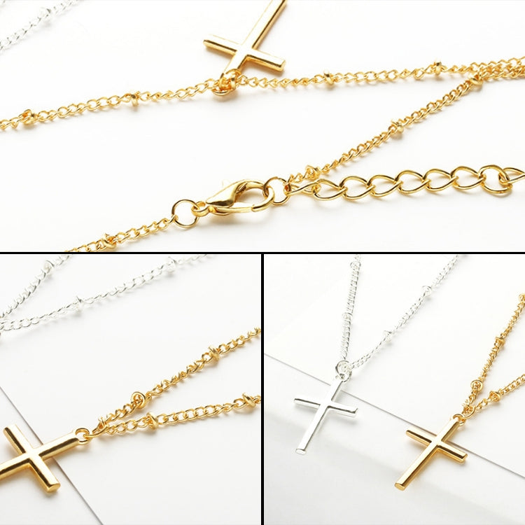 Cross pendant necklaces shown in gold and silver tones with fine chain links and charms.