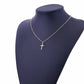 Silver cross pendant necklace on a mannequin with a delicate chain and small cross charm.