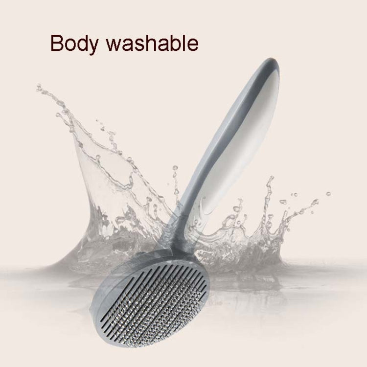 Washable pet grooming brush with gray round pin head and handle, water-splash view