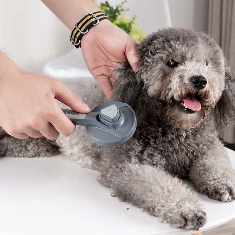 Self-cleaning pet hair brush comb with needle bristles, used on a gray dog