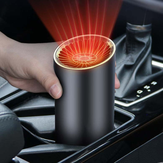 12V car cylinder heater with glowing top vent, held near center console