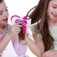 Three-strand hair braid machine in use, pink and white with hair feed guides