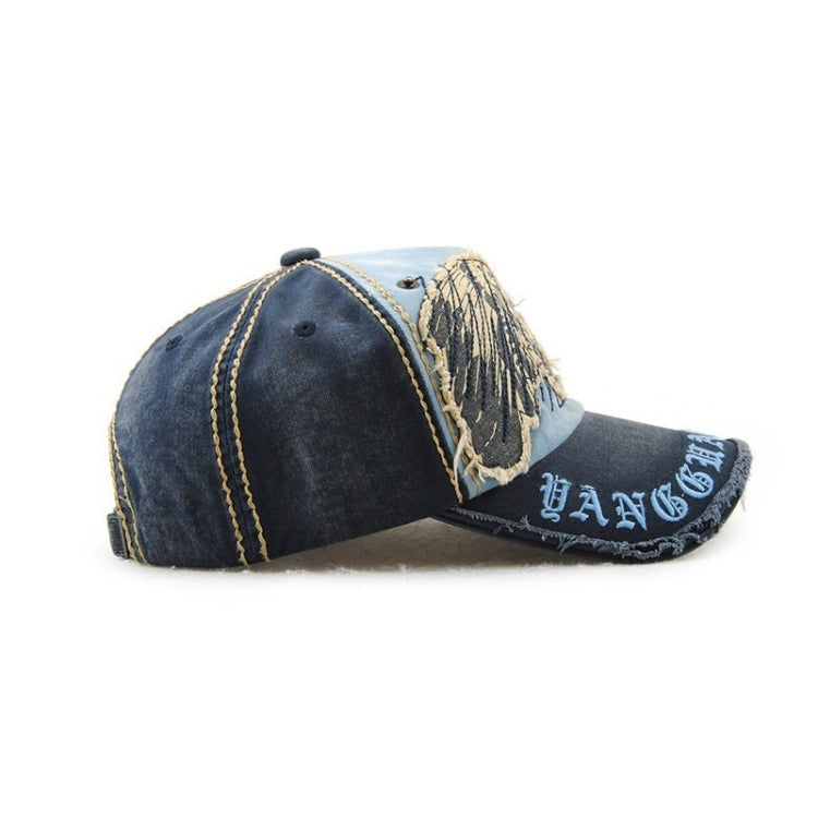 Casual baseball cap in dark denim with light blue side lettering and circular star patch details.