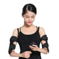 Woman in black tank top wearing arm slimming cuffs and holding remote