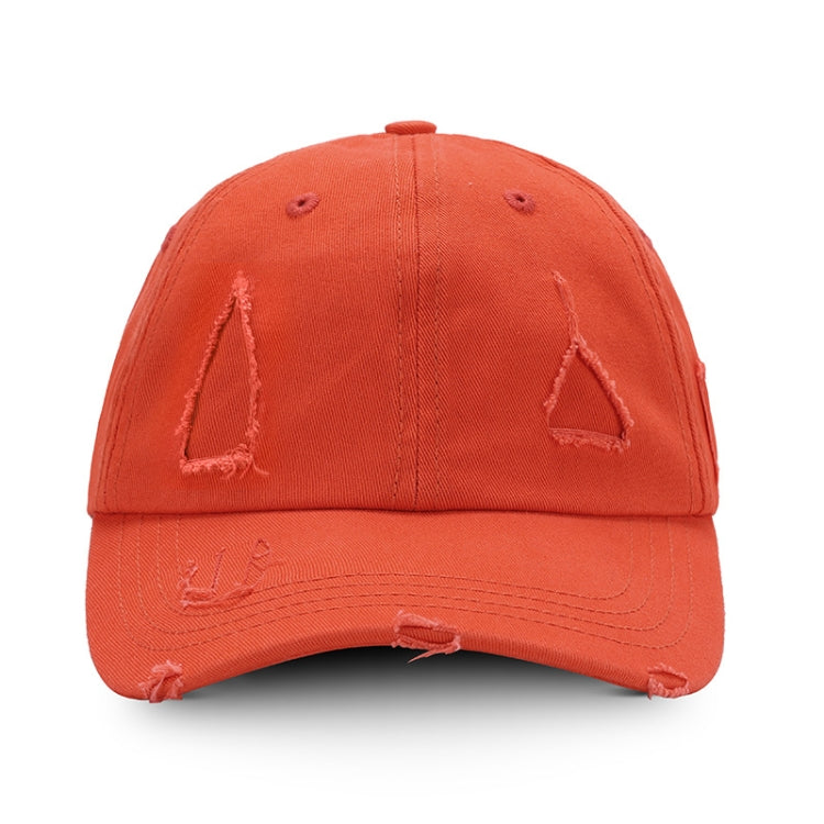 Washed orange baseball cap with distressed triangle applique and ripped brim