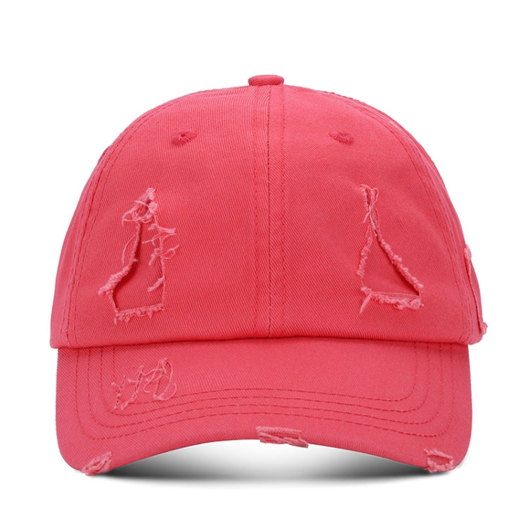 Washed pink baseball cap with distressed triangle applique and ripped brim