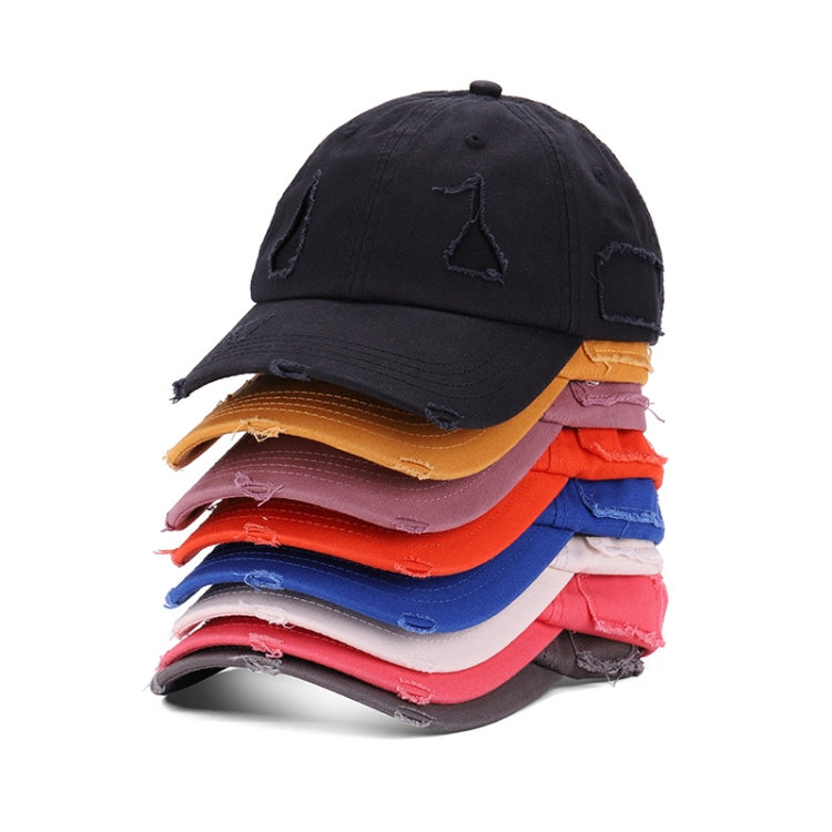 Stack of washed baseball caps in mixed colors, each with distressed triangle logo