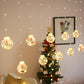 Warm white LED globe curtain lights with clear ornaments hanging near a decorated tree