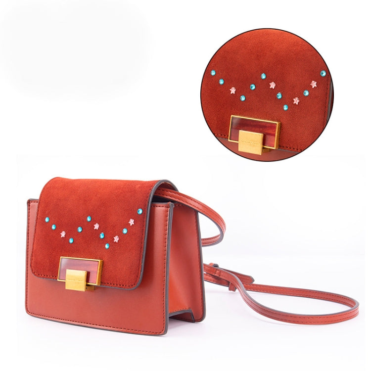 Brown crossbody bag decorated with blue and white rhinestone sticker details