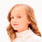 Young girl with multicolor rhinestone sticker hair accents