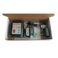 Dog training system components in open box: remote, collars, cables, and power adapter