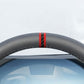 Close-up of steering wheel centering sticker showing two red accent stripes