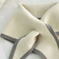 Knitted cream triangle scarf with gray border stripes and soft loop finish