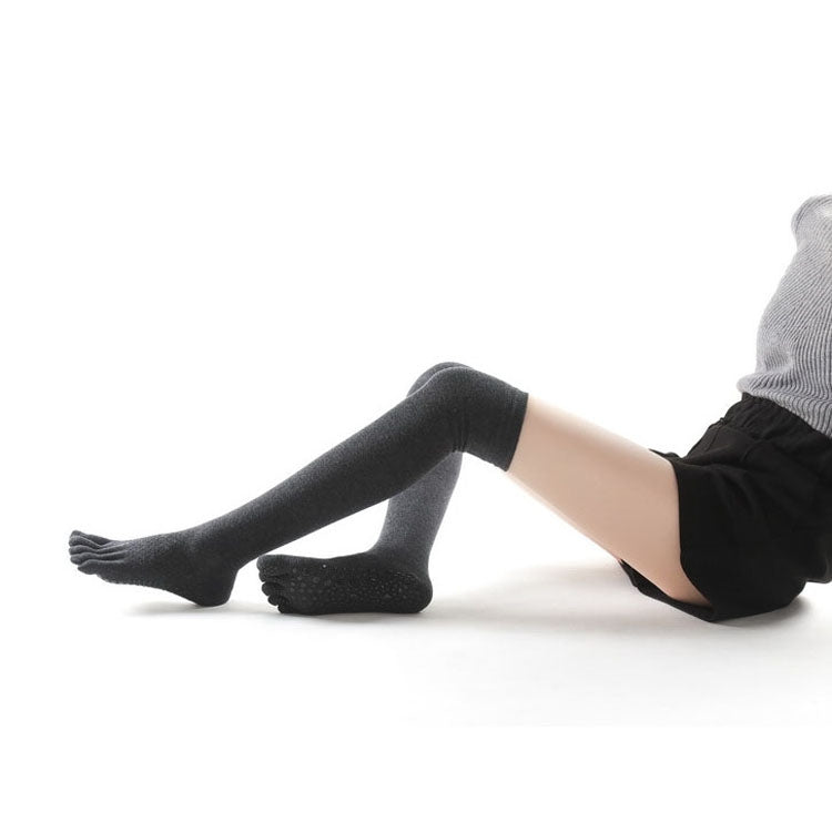 Dark gray over-the-knee five-toe yoga socks with anti-slip pads underfoot