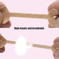 Elastic beige toe correction tape strip held between fingers, showing adhesive ends