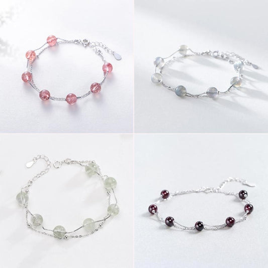 Beaded bracelet set on silver chains with pink, green, light gray, and dark red beads