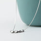 Sterling silver necklace with sculpted link charms and curved chain