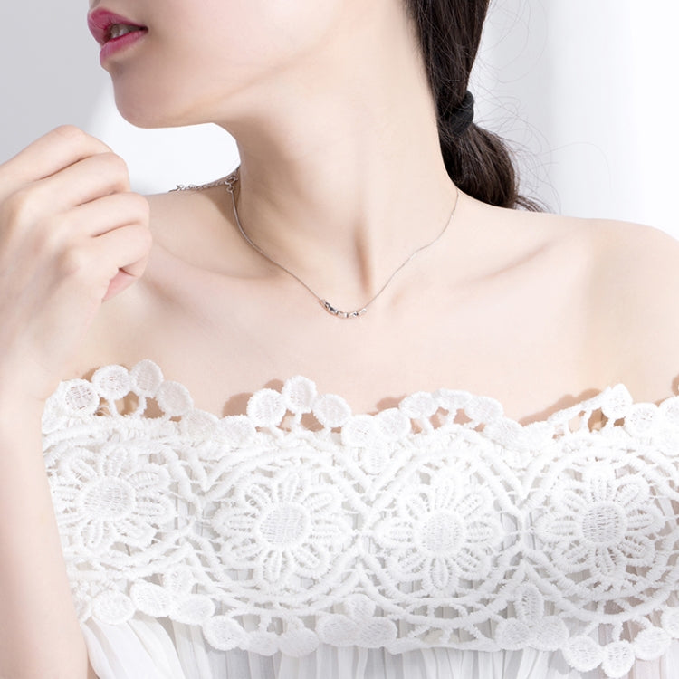 Sterling silver necklace on model with chain and link charm centerpiece