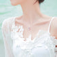 Sterling silver heart pendant necklace worn on neck with clear faceted stone