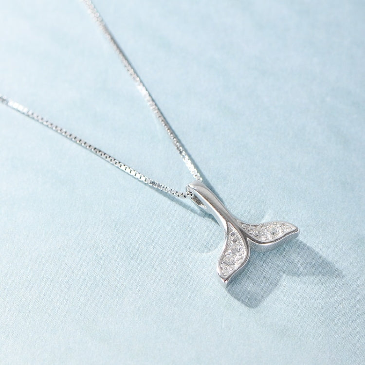 Silver whale-tail pendant necklace with sparkling detail, side view