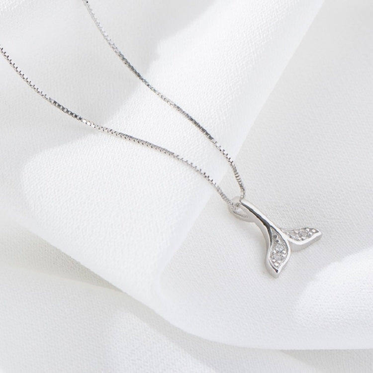 Silver fish-tail necklace with rhinestone whale-tail pendant, chain visible