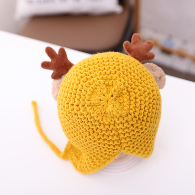 Yellow knitted baby hat with brown antler appliques and ear flaps