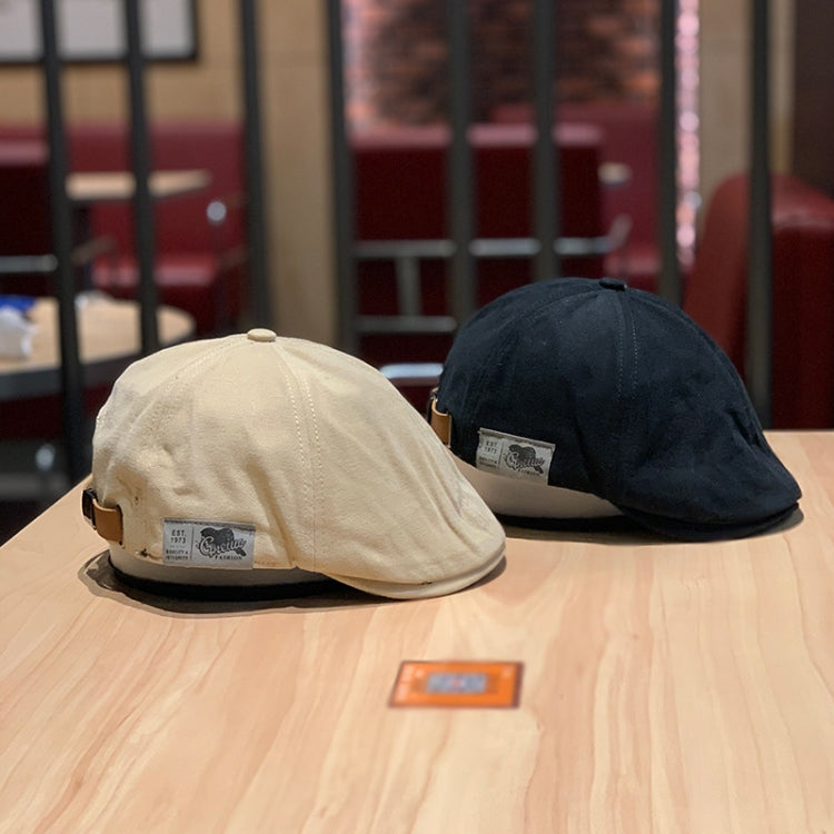 Two-tone newsboy caps: cream and black on display with stitched panels