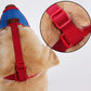 Dog muzzle with blue mesh cone and red webbing harness, side view