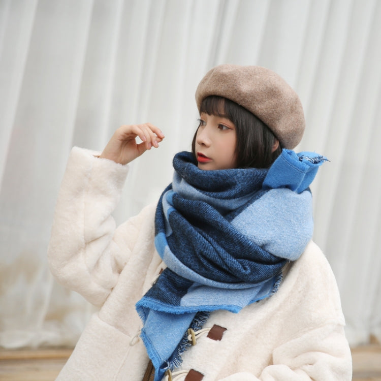 Blue geometric scarf shawl with frayed ends worn around shoulders
