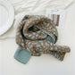 Kids knitted leopard-pattern scarf, light blue and brown, folded