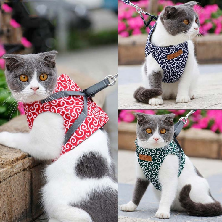 Cat wearing blue patterned traction chest harness with rope leash attached