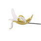 Banana-shaped table lamp with gold banana body and white bulb, stretched pose