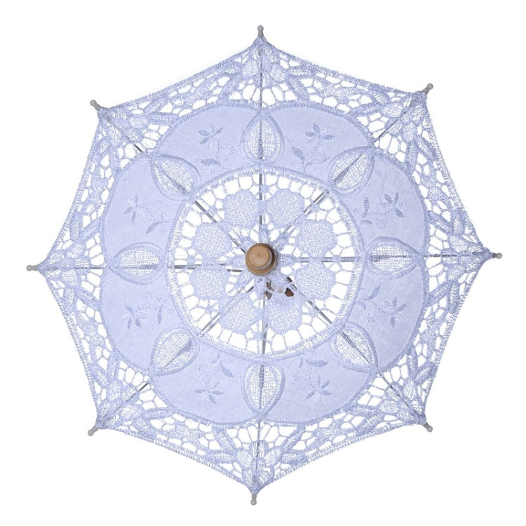 White lace bridal umbrella with floral cutout pattern and wooden center knob