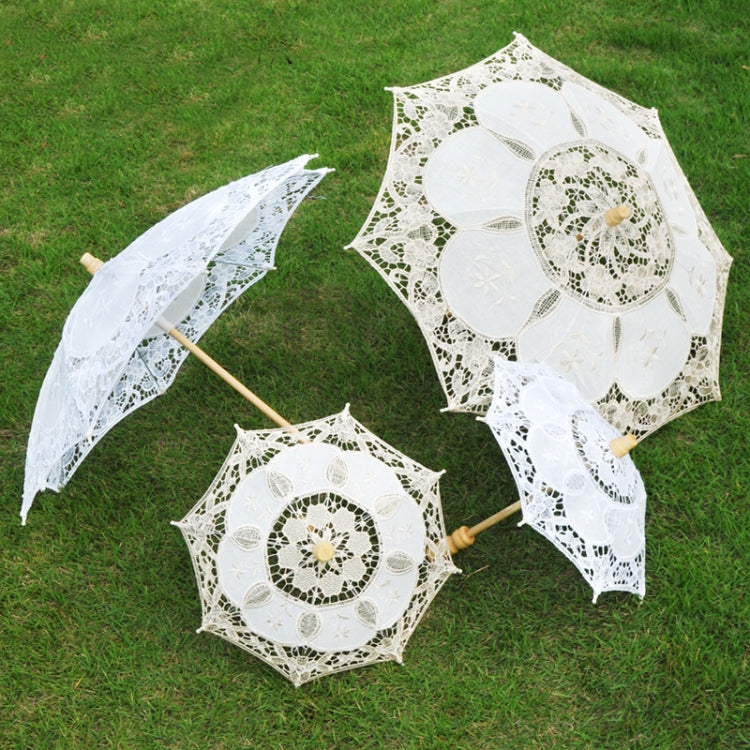 White lace mini parasols set with round embroidered medallion centers and wooden handles